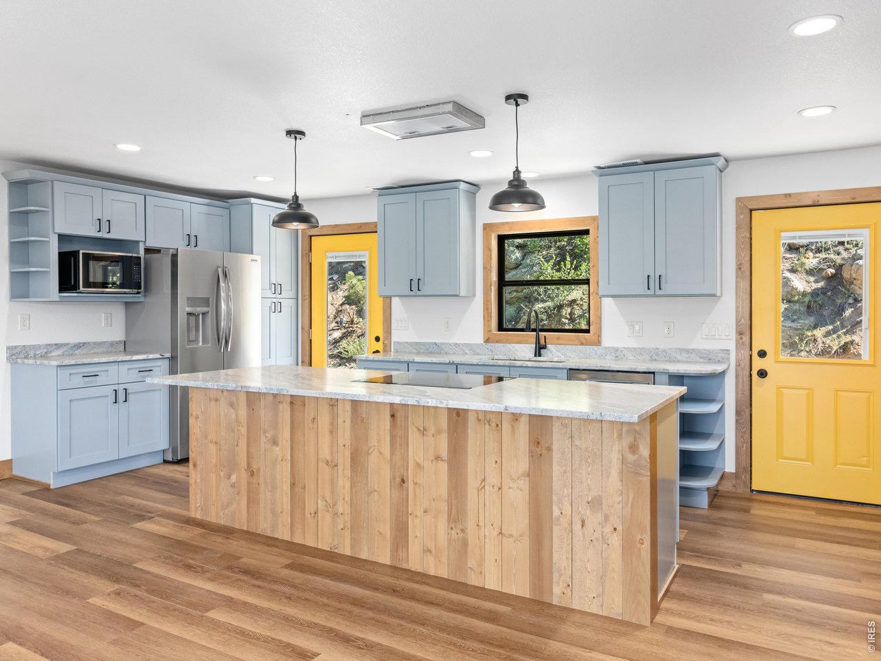 Property Photo 4 At the heart of the home is a state-of-the-art kitchen with all-new stainless steel appliances and a large center island with breakfast bar seating