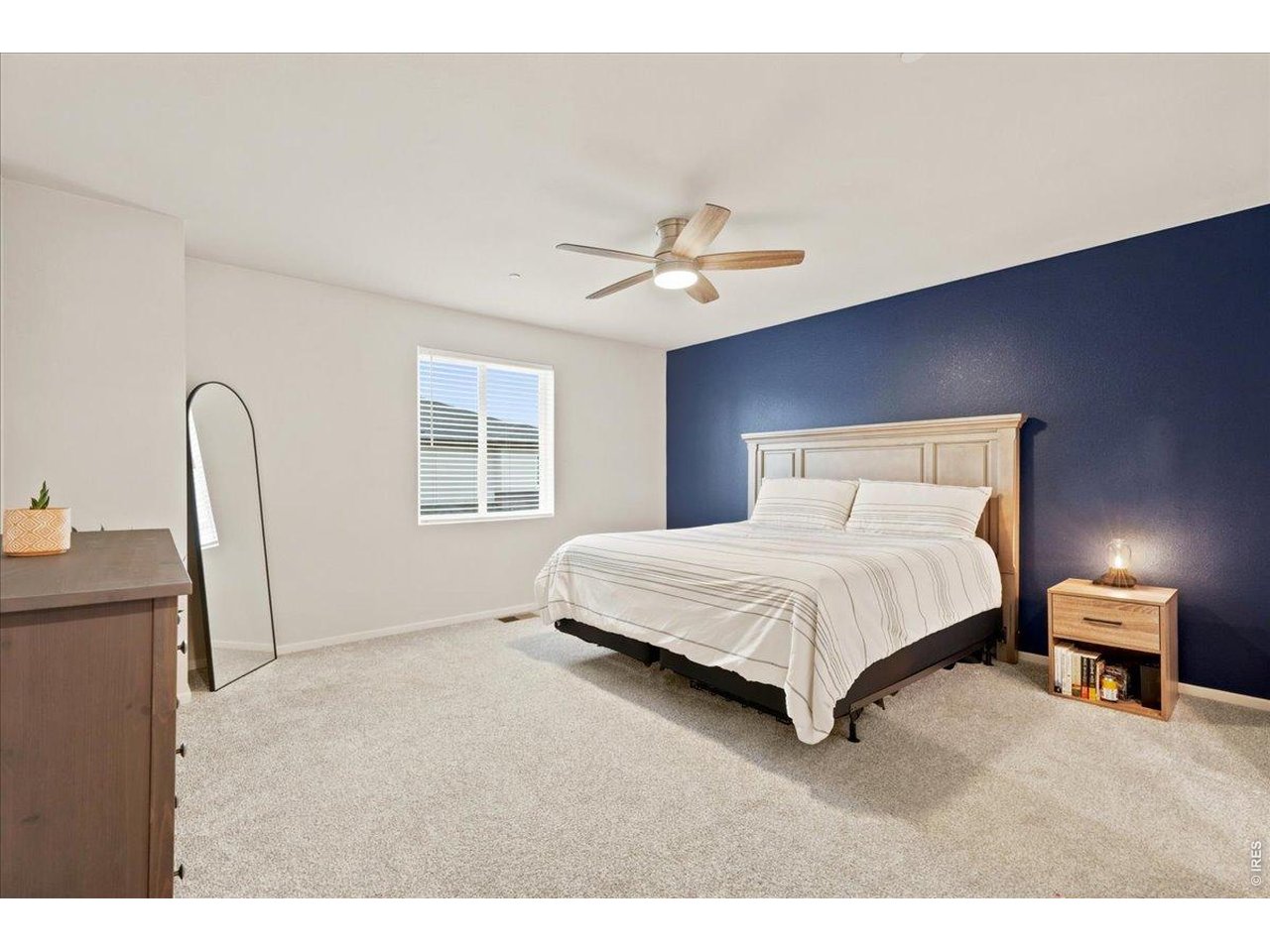 Property Photo 9 Primary suite with a designer navy accent wall. Big enough for a king bed and then some.