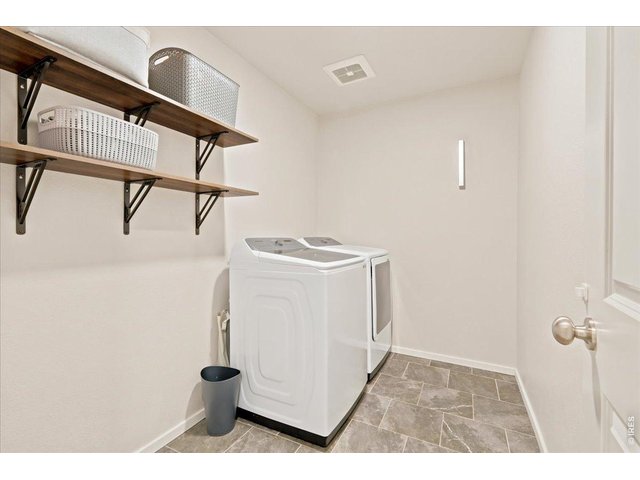 Property Photo 15 2nd Floor Laundry Room with shelving.