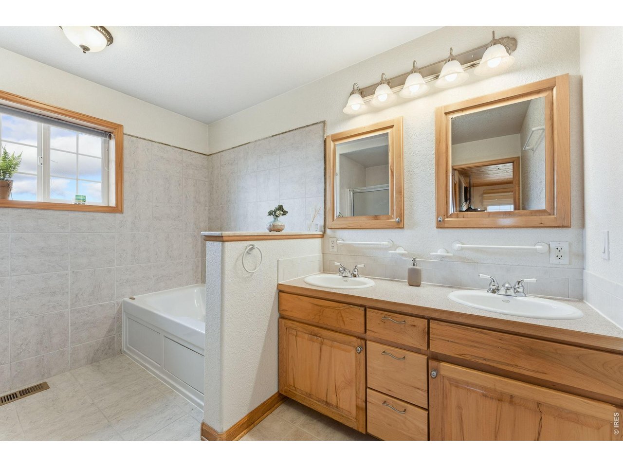 Property Photo 16 Five piece primary bath with beautiful warm wood finishes