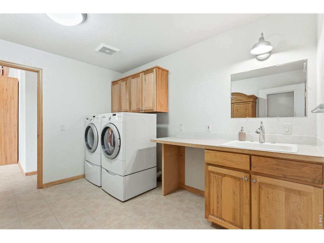 Property Photo 22 Extra spacious laundry area with sink and lots of storage! Bosch Washer and Dryer are included!