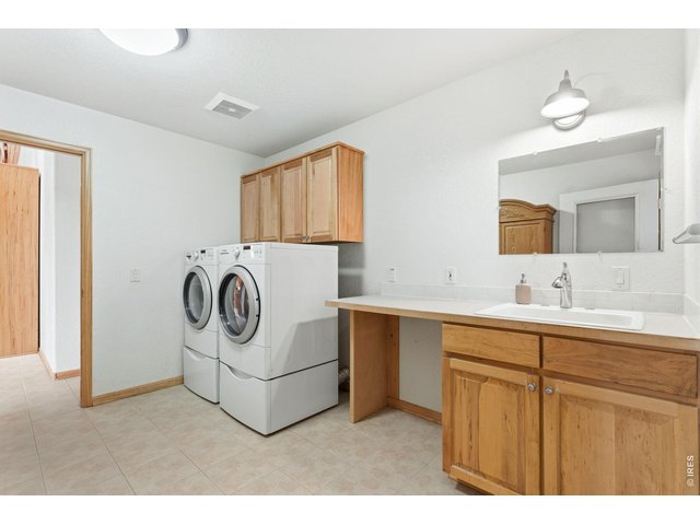 Property Photo 22 Extra spacious laundry area with sink and lots of storage! Bosch Washer and Dryer are included!