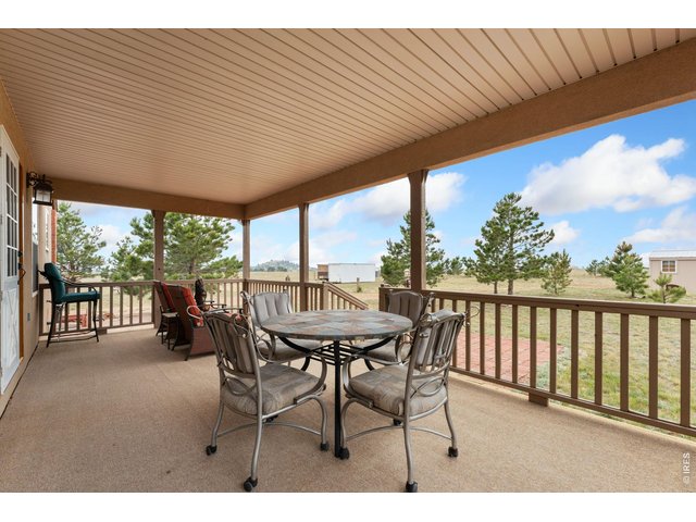 Property Photo 25 Expansive, fully covered back deck, perfect for enjoying morning coffee in the peace and beauty of nature!