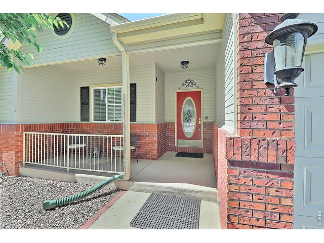 Property Photo 3 Charming Covered Front Porch Welcomes Family and Friends