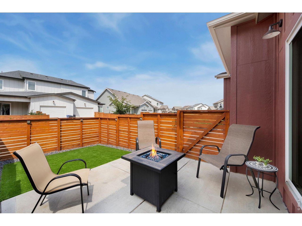 Property Photo 22 Fully fenced yard with large patio and artificial turf for lock-and-leave convenience