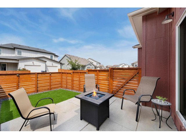 Property Photo 22 Fully fenced yard with large patio and artificial turf for lock-and-leave convenience