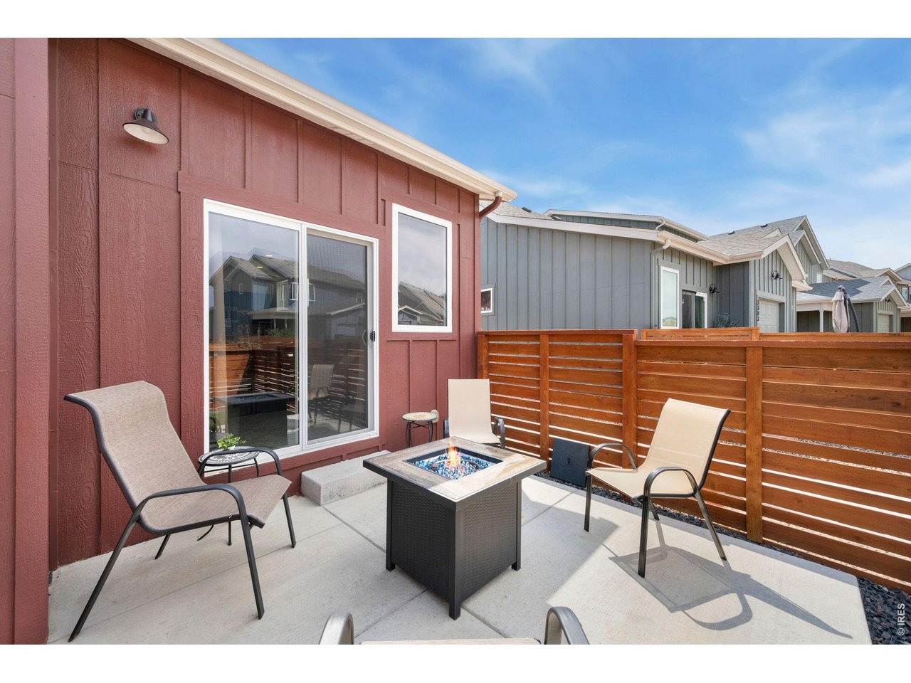 Property Photo 21 Fully fenced yard with large patio and artificial turf for lock-and-leave convenience
