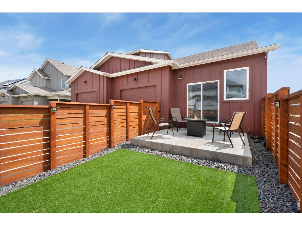 Property Photo 23 Fully fenced yard with large patio and artificial turf for lock-and-leave convenience