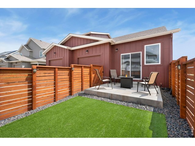 Property Photo 23 Fully fenced yard with large patio and artificial turf for lock-and-leave convenience