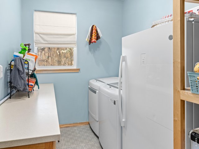 Property Photo 34 Generous laundry room with folding counter