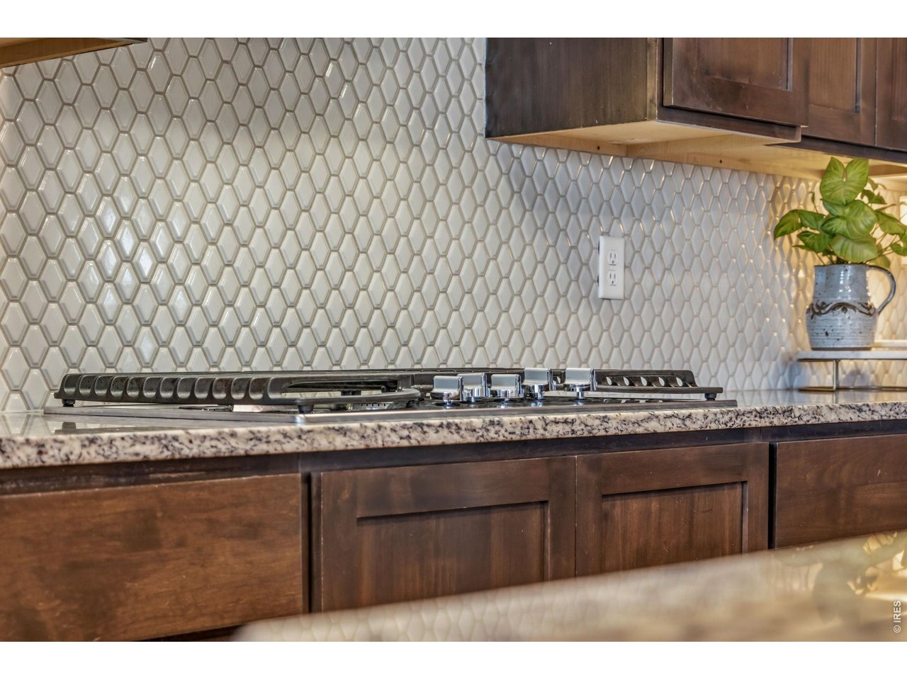 Property Photo 20 Eye-catching tile backsplash adds timeless style to the kitchen. 36" gas range.