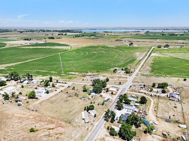 Property Photo 2 Aerial view from the home looking toward the lake; yes, that's how close it is!