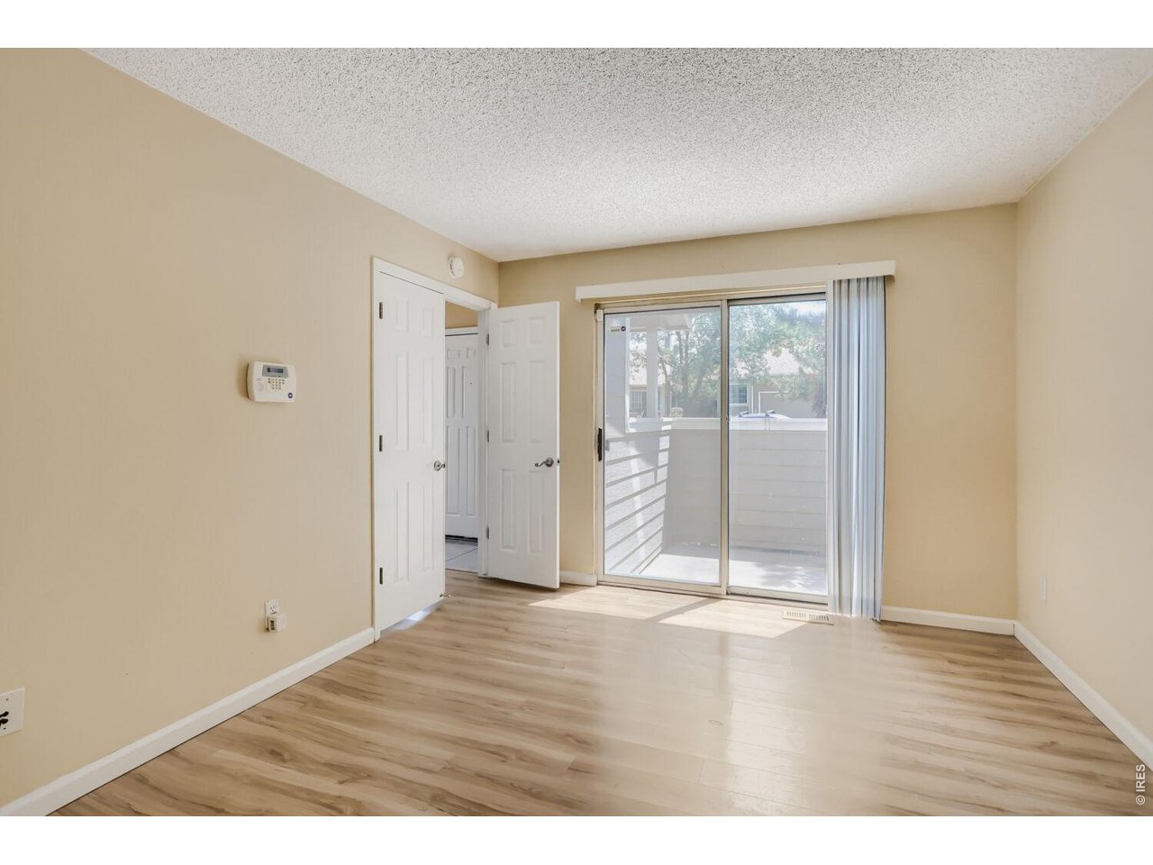 Main-level bedroom with private pato