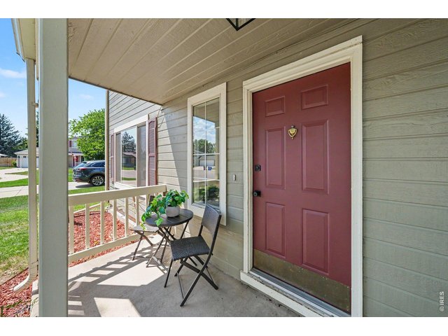Property Photo 2 Inviting, covered front porch with a charming bistro seating area