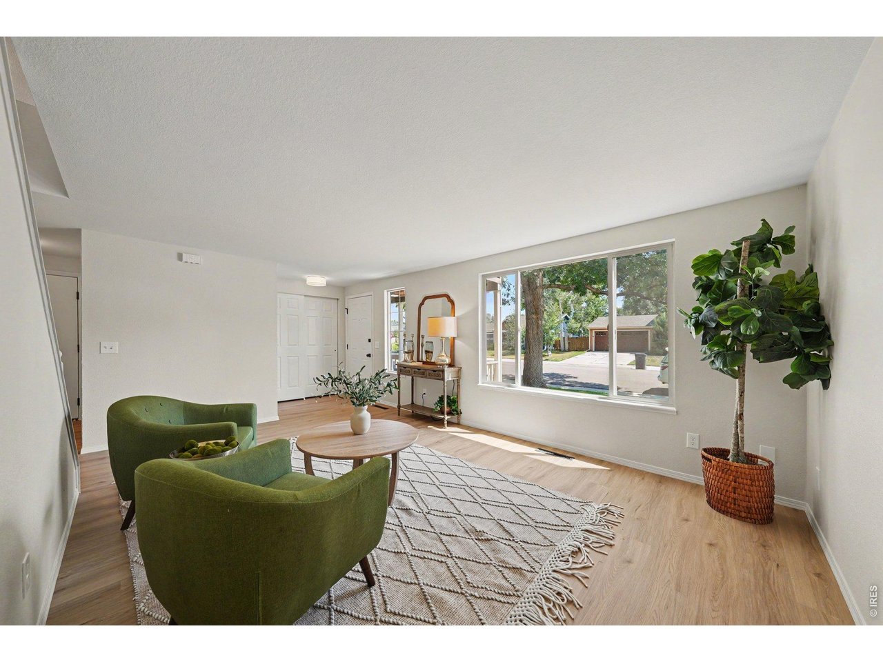 Property Photo 3 Bright living space and large front window.