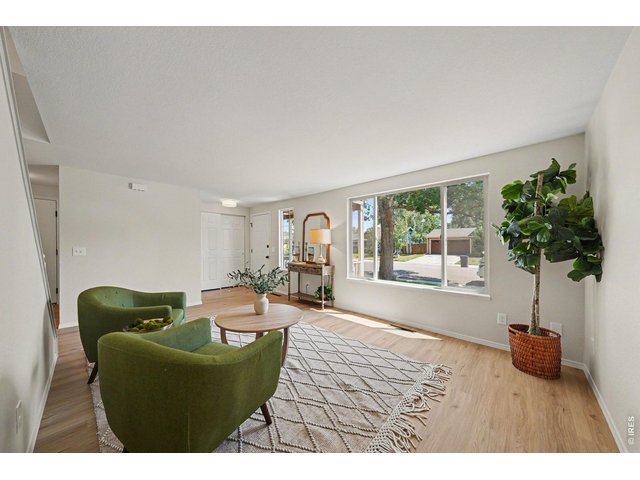 Property Photo 3 Bright living space and large front window.