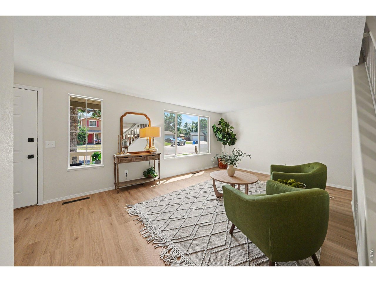 Property Photo 4 Bright, open living room with beautiful new flooring and abundant natural light.
