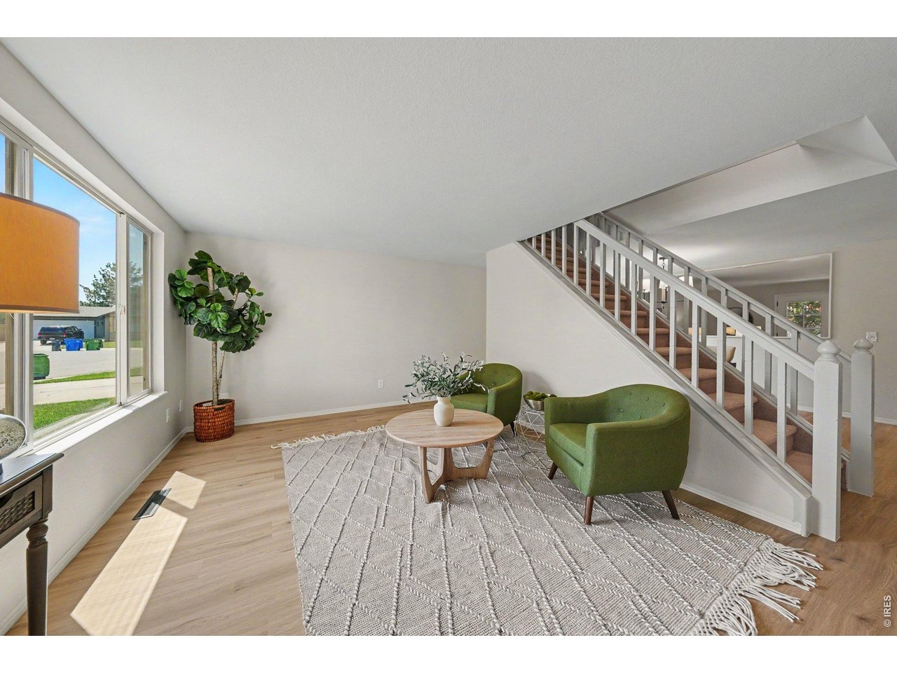 Property Photo 5 Stylish living area looking toward the staircase, highlighting the beautiful modern layout.