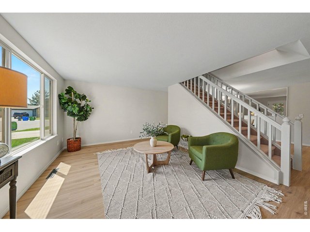 Property Photo 5 Stylish living area looking toward the staircase, highlighting the beautiful modern layout.