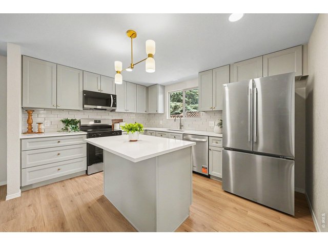 Property Photo 13 Gorgeous, completely remodeled kitchen featuring light-colored stone countertops, grey cabinetry