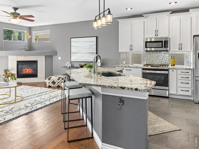 Property Photo 2 The open-concept layout creates a seamless transition between the gourmet kitchen and the inviting living area, making it perfect for both daily living and entertaining. The fluid floor plan ensures that the chef stays connected