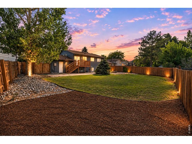 Property Photo 42 Outside, the improvements continue with refreshed landscaping, new mulch and river rock, front yard sprinklers, an updated deck, repaired and stained fencing, new lighting, and additional exterior improvements that create exceptional curb appeal.