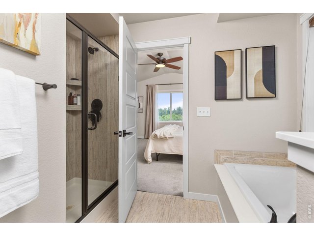 Property Photo 19 Primary bathroom with seperate shower and bath tub.