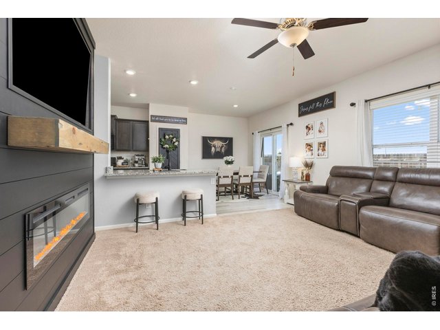 Property Photo 6 Featuring a fireplace with a custom mantle, designer accent walls, and quality upgrades throughout, this home offers standout character and modern comfort.