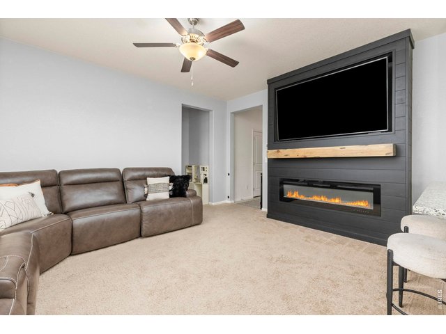 Property Photo 8 The open floor plan connects the spacious living room to the kitchen and dining area for easy everyday living and entertainment.