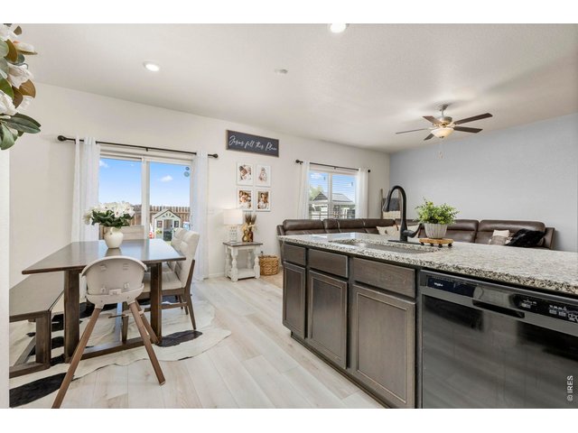 Property Photo 11 Durable laminate flooring runs throughout the main living spaces for style and easy maintenance.