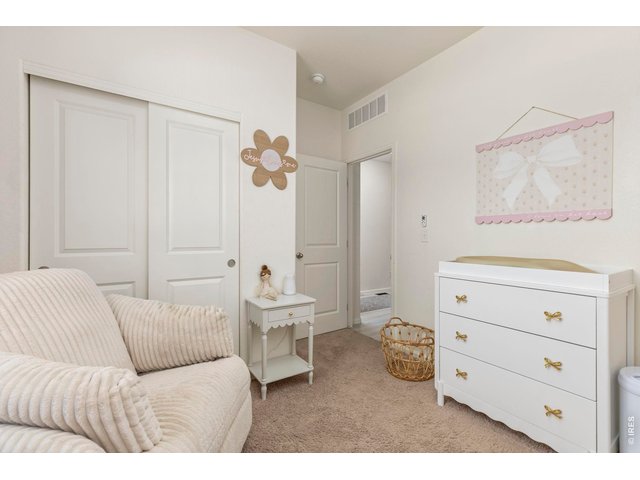 Property Photo 20 Two additional bedrooms offer flexibility for guests, a home office, or hobbies, including one with custom picture frame molding.