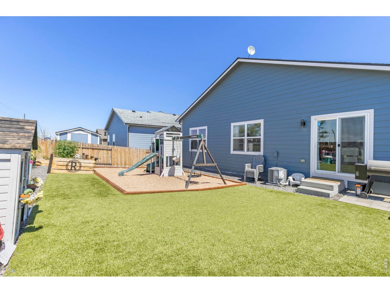 Property Photo 24 The south-facing orientation helps promote faster snow melt during winter months. Additional highlights include a new roof (2026) with a transferable warranty, central A/C, fresh interior paint, newly finished baseboards, and an easy commute to Denver, Bri