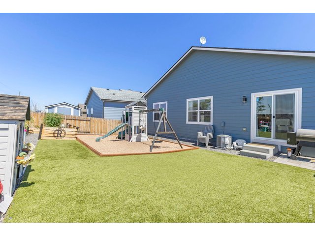 Property Photo 24 The south-facing orientation helps promote faster snow melt during winter months. Additional highlights include a new roof (2026) with a transferable warranty, central A/C, fresh interior paint, newly finished baseboards, and an easy commute to Denver, Bri