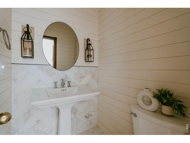 Property Photo 24 Main floor powder bath with marble tile