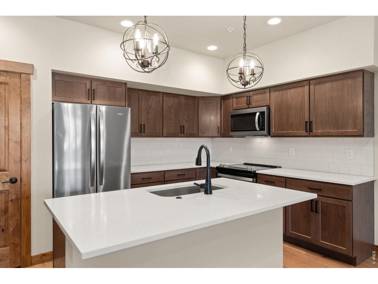 Property Photo 6 Large island with quartz counter tops.