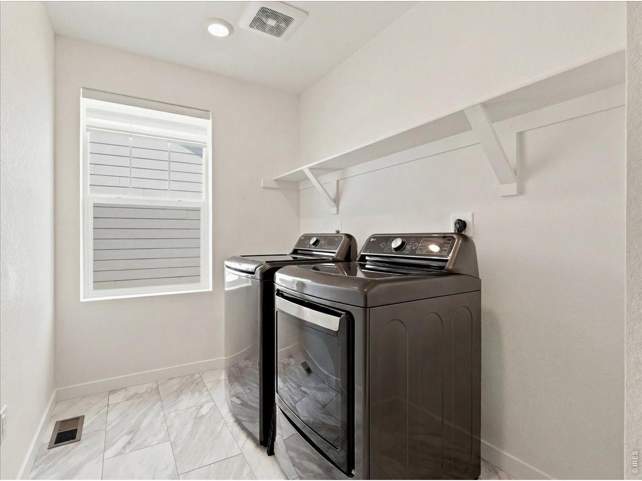 Property Photo 13 Dedicated laundry space upstairs where you need it.