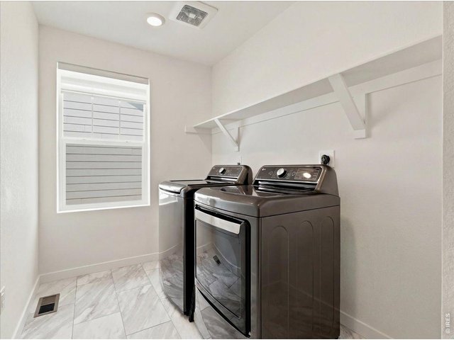 Property Photo 13 Dedicated laundry space upstairs where you need it.
