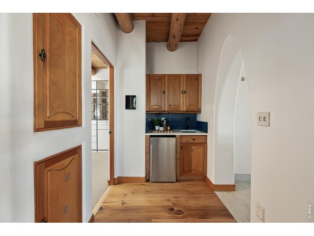 Property Photo 28 A convenient wet bar within the primary suite offers a private retreat with added comfort for morning coffee or evening unwind.
