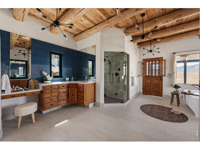 Property Photo 30 A spa-inspired primary bath retreat featuring dual vanities, a steam shower, and a soaking tub perfectly positioned to capture unobstructed views.