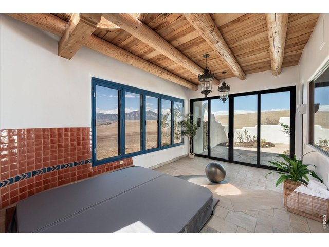 Property Photo 33 A serene jacuzzi and wellness room with skylights, expansive windows, and sliding doors to the private courtyard, offering unobstructed views and seamless access from the primary suite.