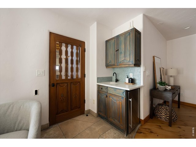 Property Photo 41 A stylish wet bar with custom cabinetry and sink offers the perfect setup for hosting and serving guests with ease.