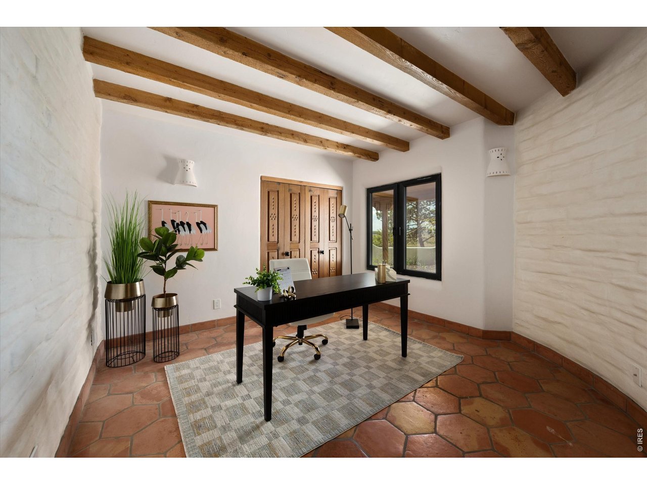 Property Photo 39 Bedroom 3 - 17 x 13 A versatile office or bedroom with warm wood beams and natural light, featuring a separate exterior access just outside the door, ideal for a home-based business or private client entry.