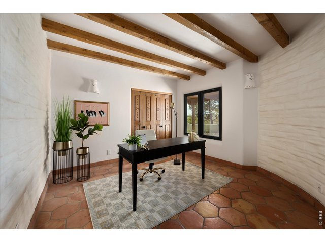 Property Photo 39 Bedroom 3 - 17 x 13 A versatile office or bedroom with warm wood beams and natural light, featuring a separate exterior access just outside the door, ideal for a home-based business or private client entry.