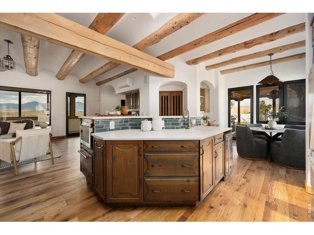 Property Photo 15 The upper main level features a beautifully updated kitchen, quartz countertops, and new backsplash.