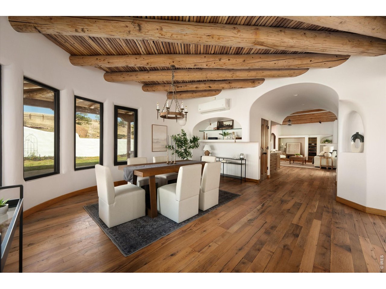 Property Photo 11 A warm, dining space with expansive windows that blur the line between indoor comfort and the surrounding natural landscape.