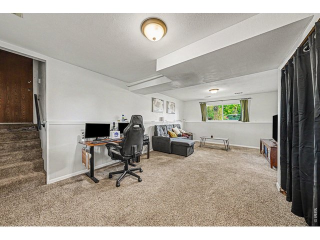 Property Photo 12 Lower level living space perfect for another lounge space, office, or playroom
