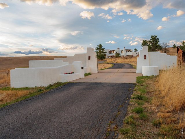 Property Photo 2 Behind a private gated entrance, the residence unfolds across approximately 5,800 square feet.