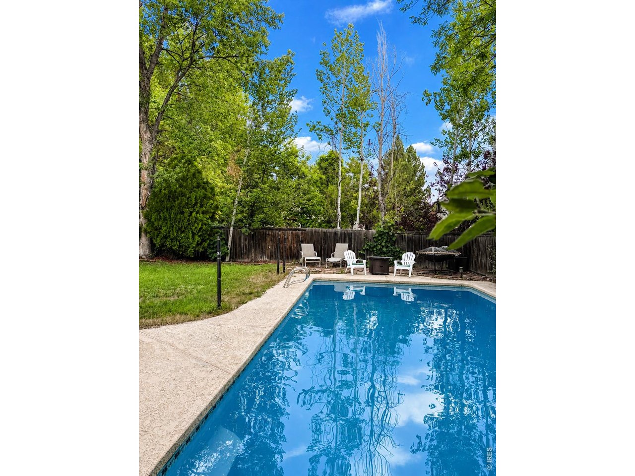 In ground pool with a large, level yard which backs to a trail so is quiet & peaceful.