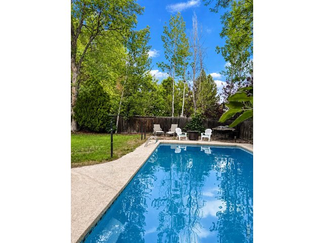 Property Photo 4 In ground pool with a large, level yard which backs to a trail so is quiet & peaceful.