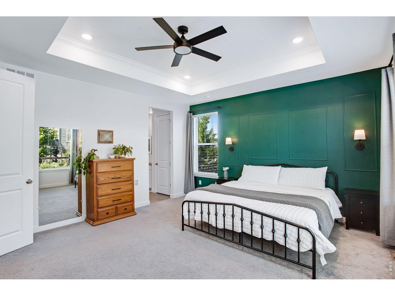 Property Photo 17 oversized primary bedroom with tray ceiling, can lighting and upgrade ceiling fan